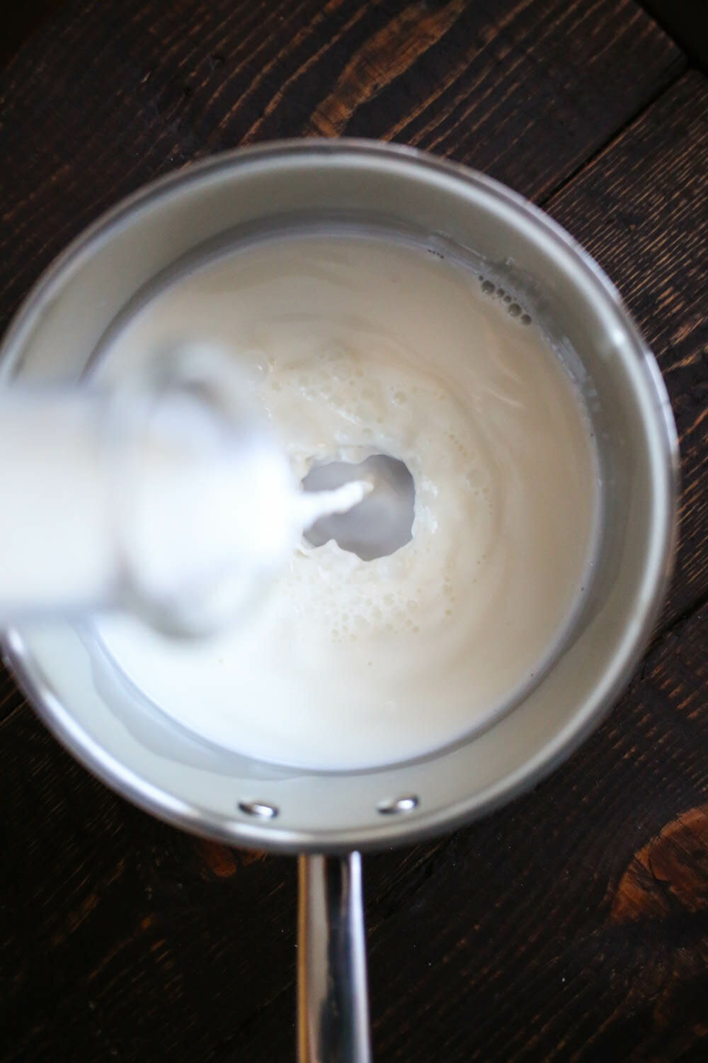 Pouring milk into pan