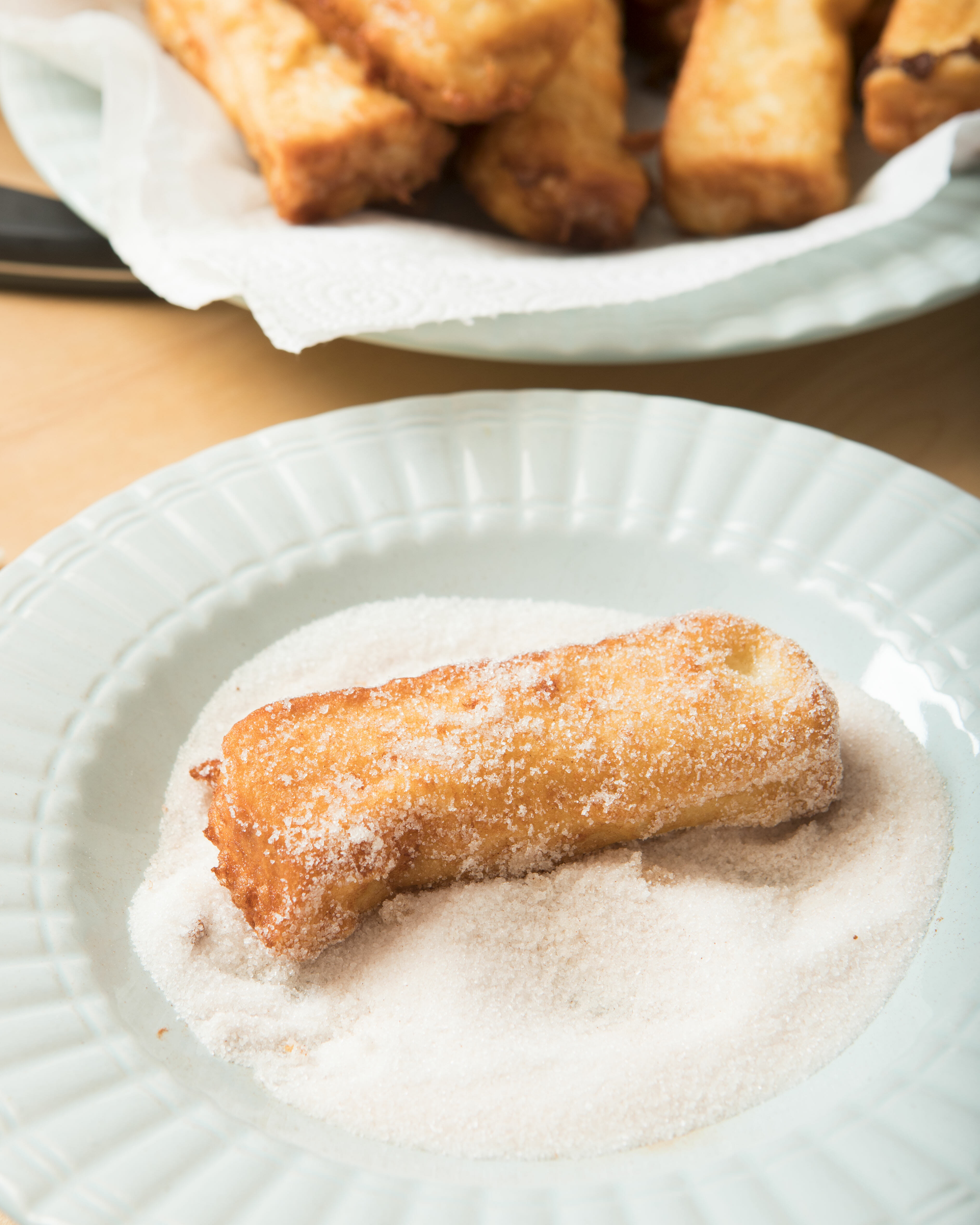 rolling french toast in cinnamon sugar