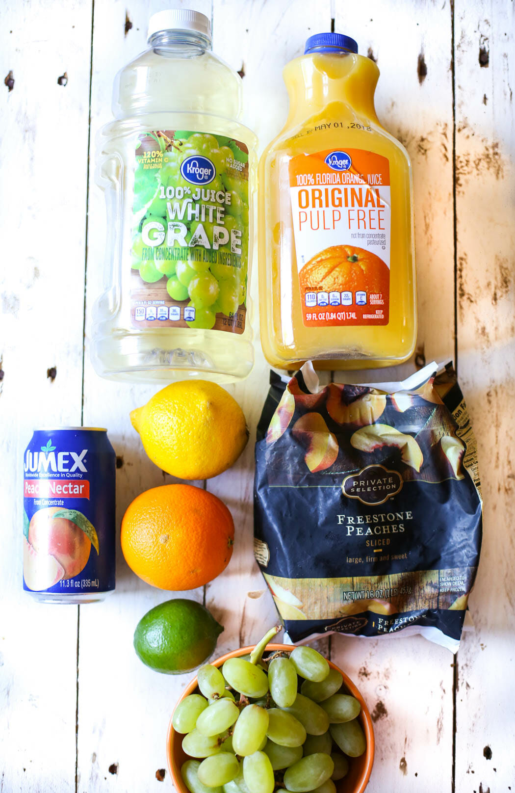 Fruit and juice for virgin white peach sangria from Our Best Bites