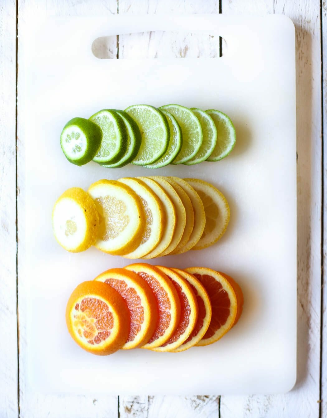 sliced lemons, limes, and orange for virgin white peach sangria from Our Best Bites