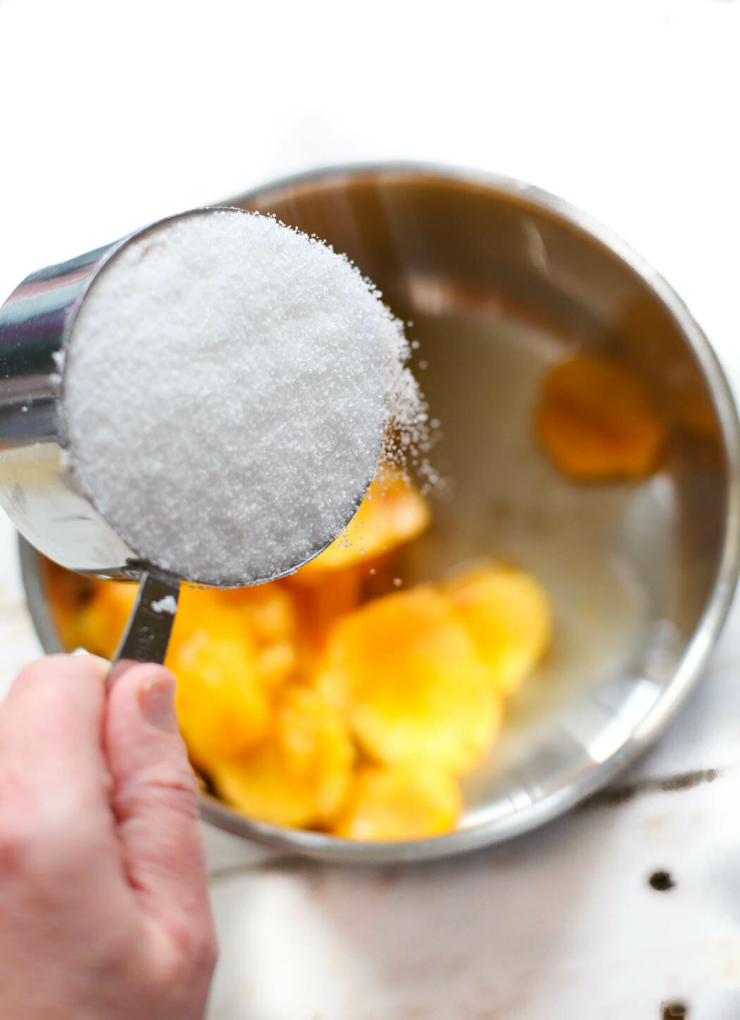 adding sugar to peaches for peach syrup