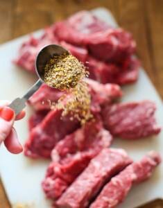 Sprinkling Steak Seasoning on pot roast