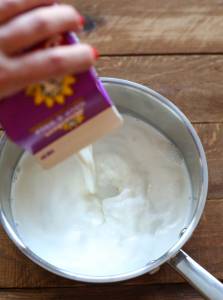 pouring half and half into medium saucepan