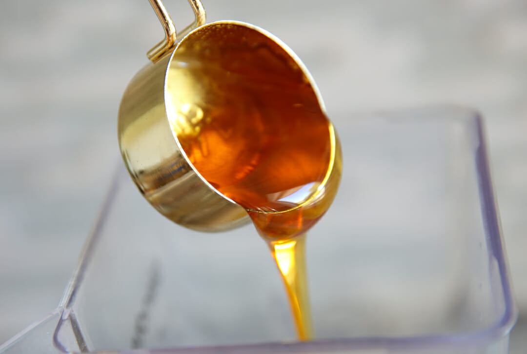 pouring honey from measuring cup
