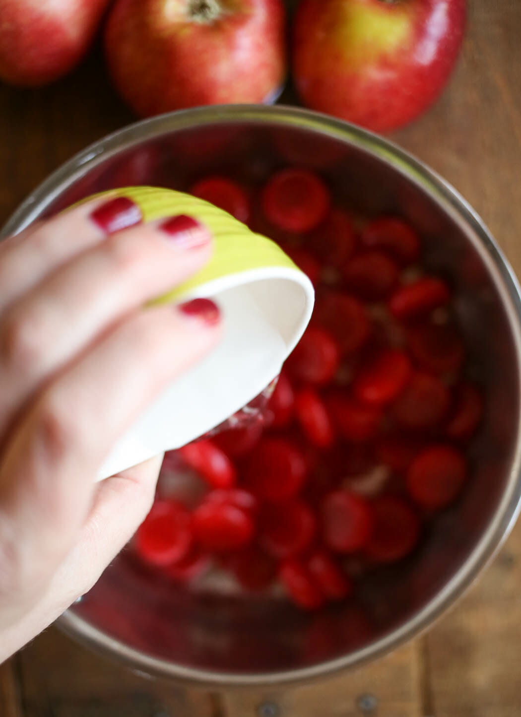 adding water to cinnamon candy apples