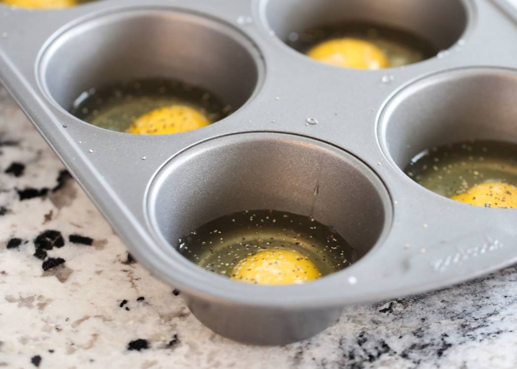 Raw eggs in a muffin tin. 