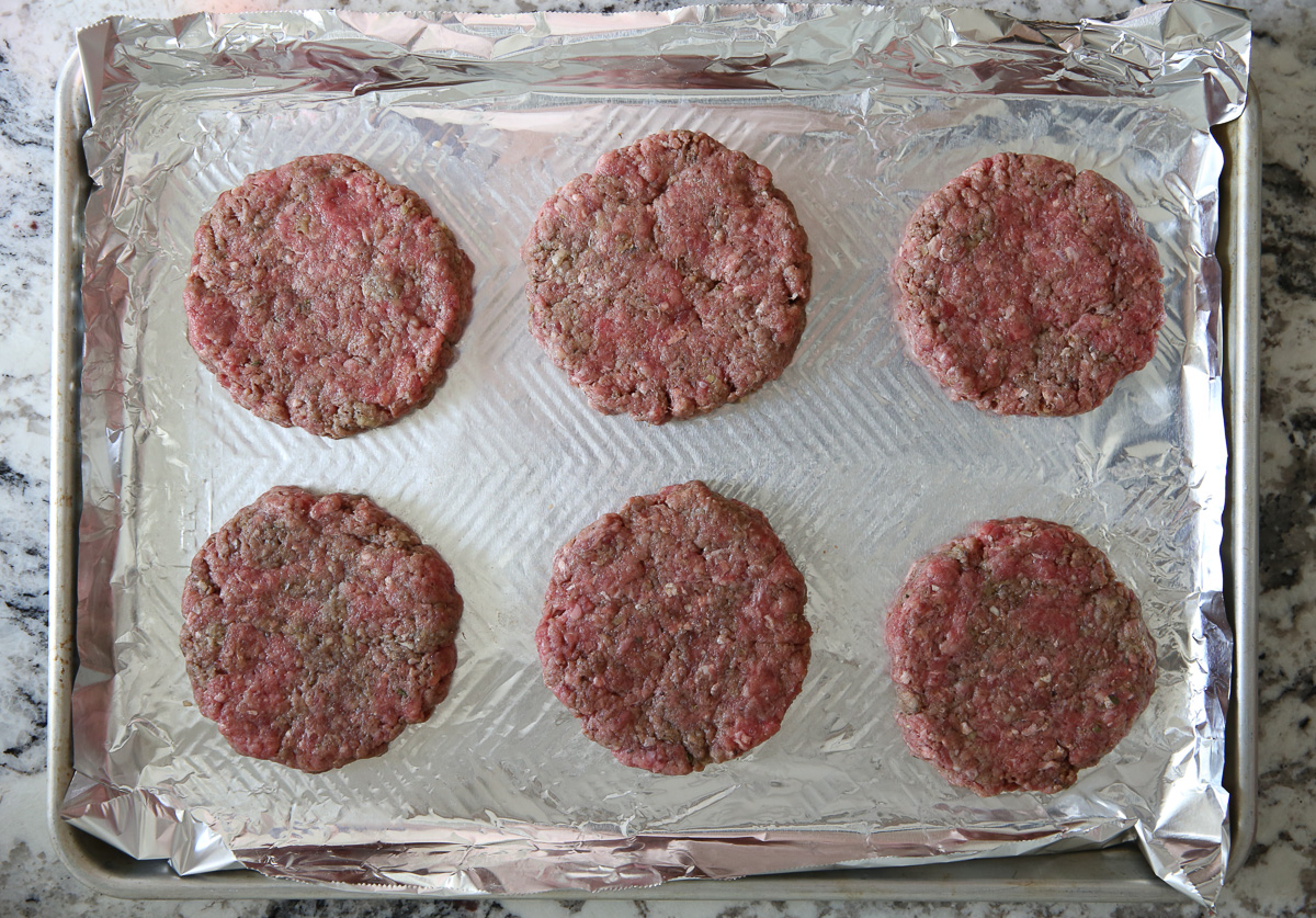 raw burgers shaped into patties