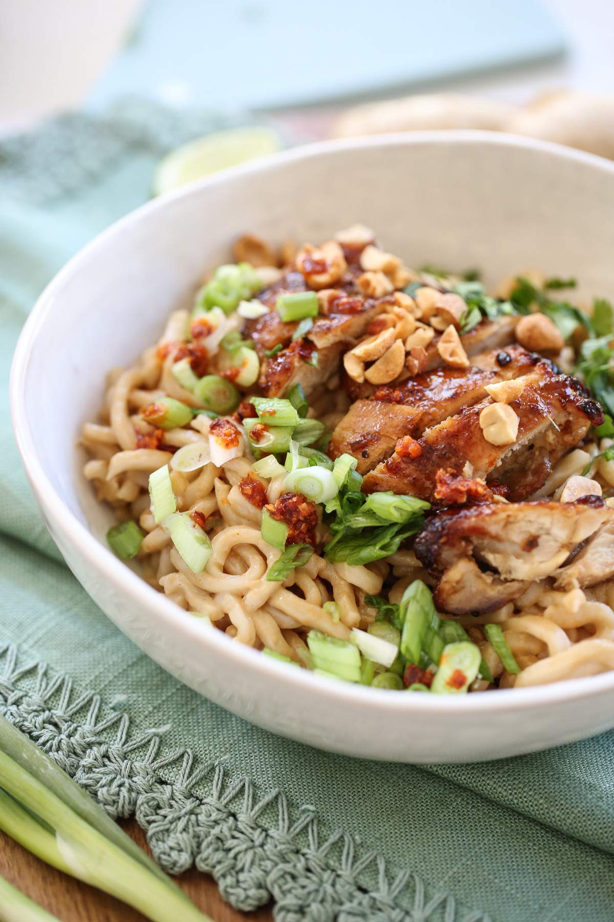 Thai Peanut Noodles in a white bowl with toppings