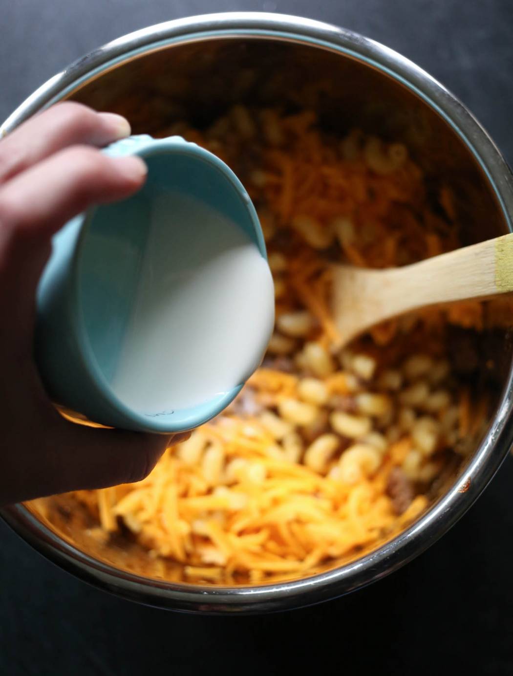adding half and half to instant pot cheeseburger macaroni from our best bites