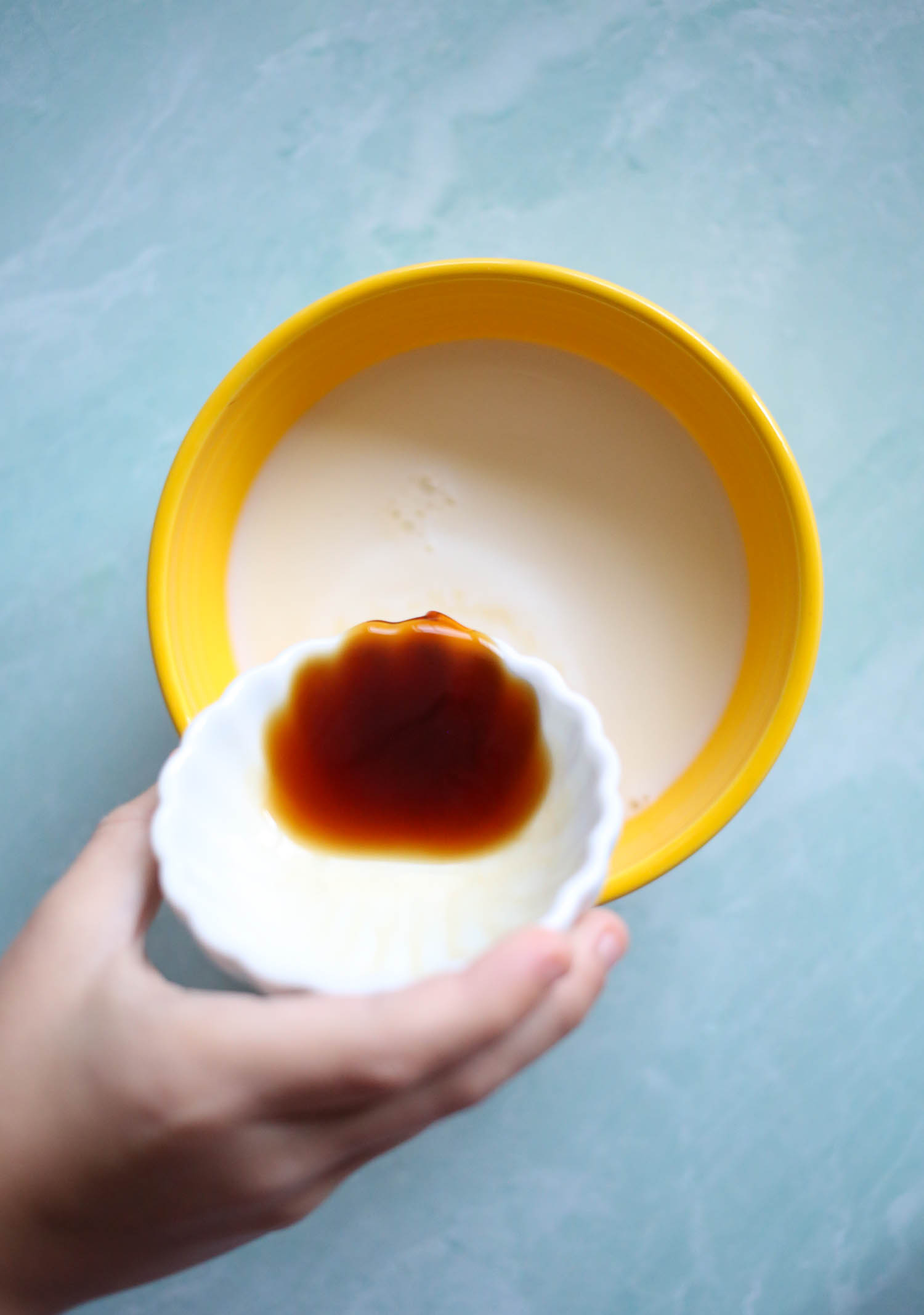 adding vanilla to milk for mixed berry baked oatmeal from our best bites