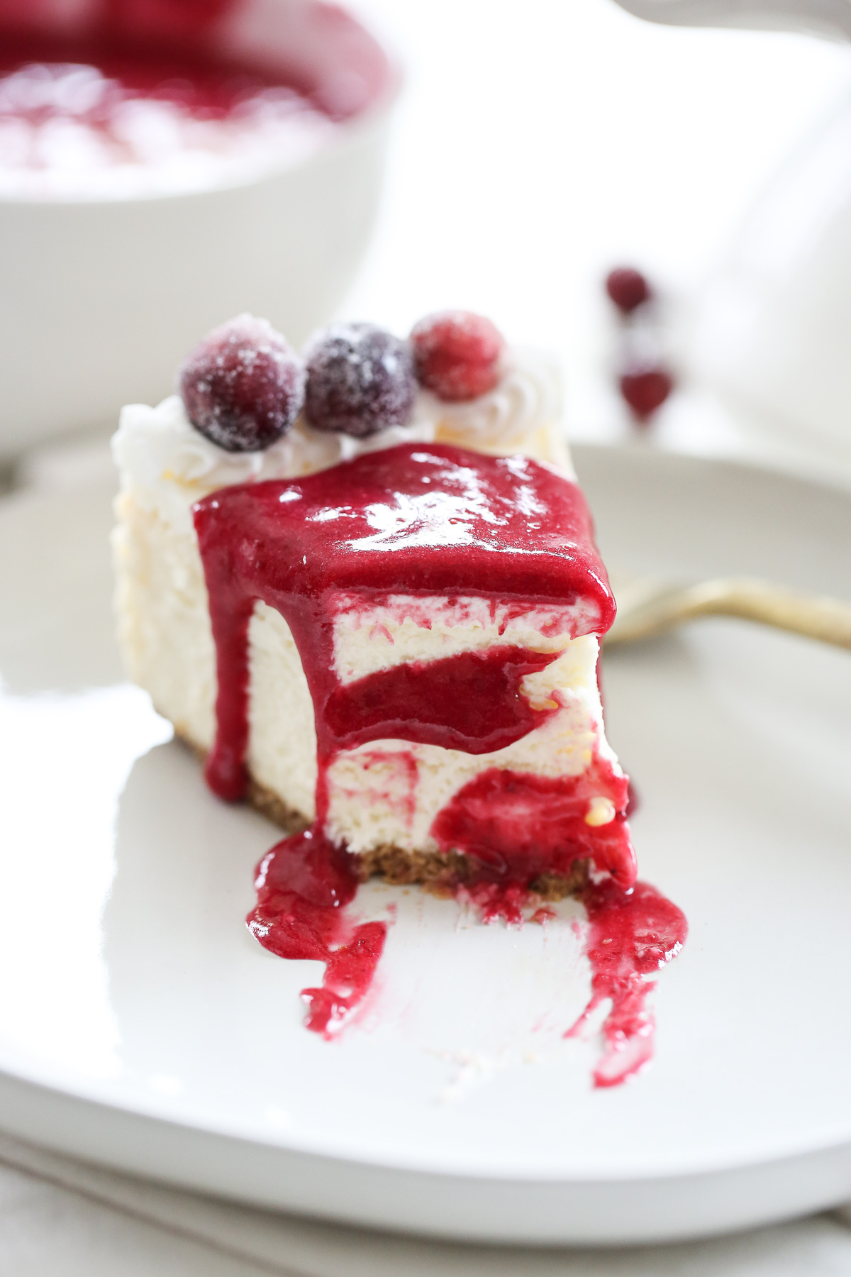slice of cheesecake with cranberry sauce on it