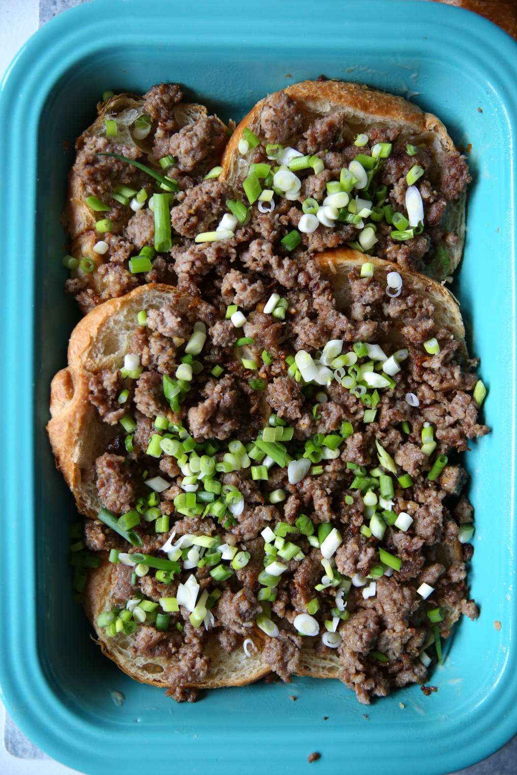 green onions and sausage on croissants