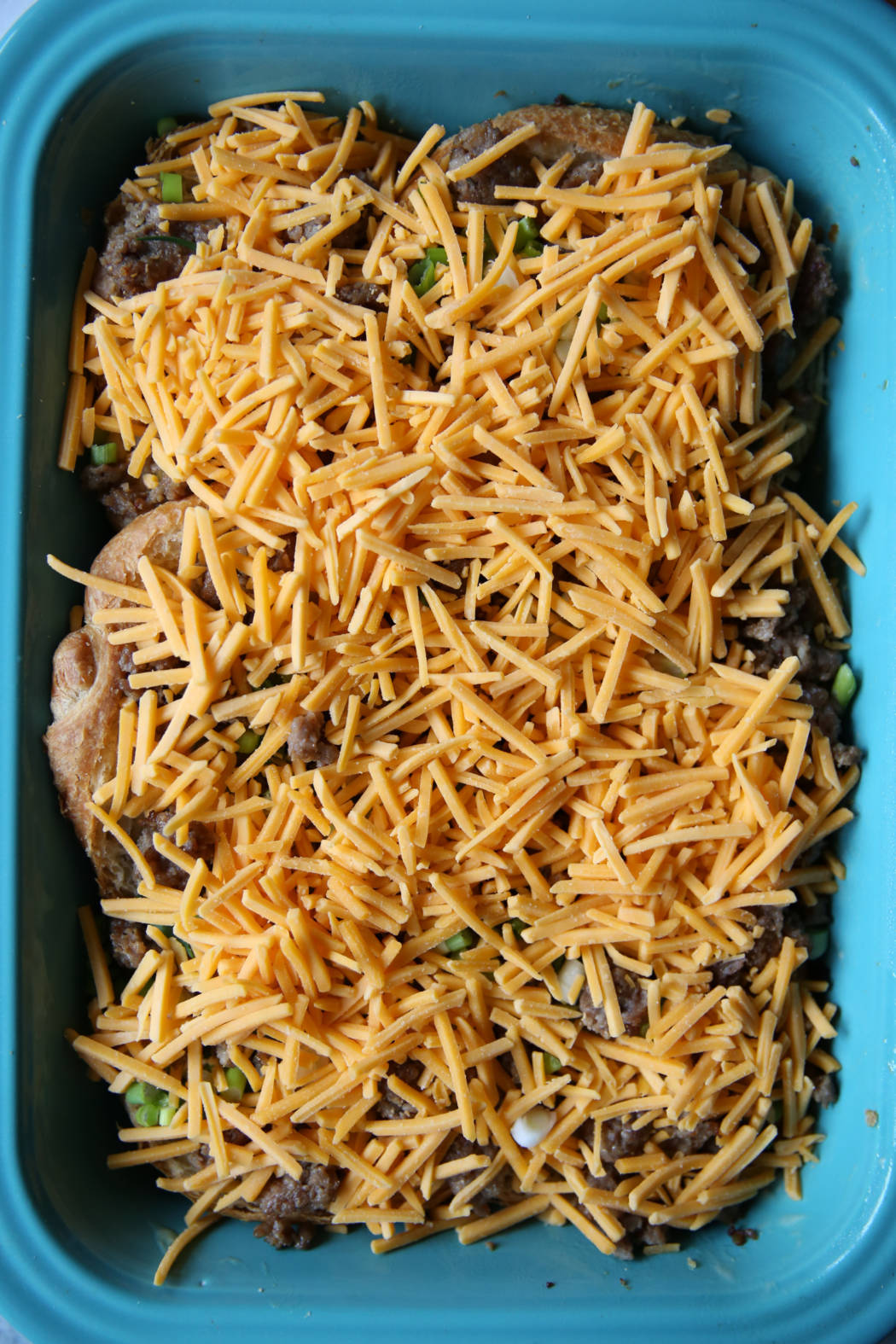 cheese sausage and green onions on croissants