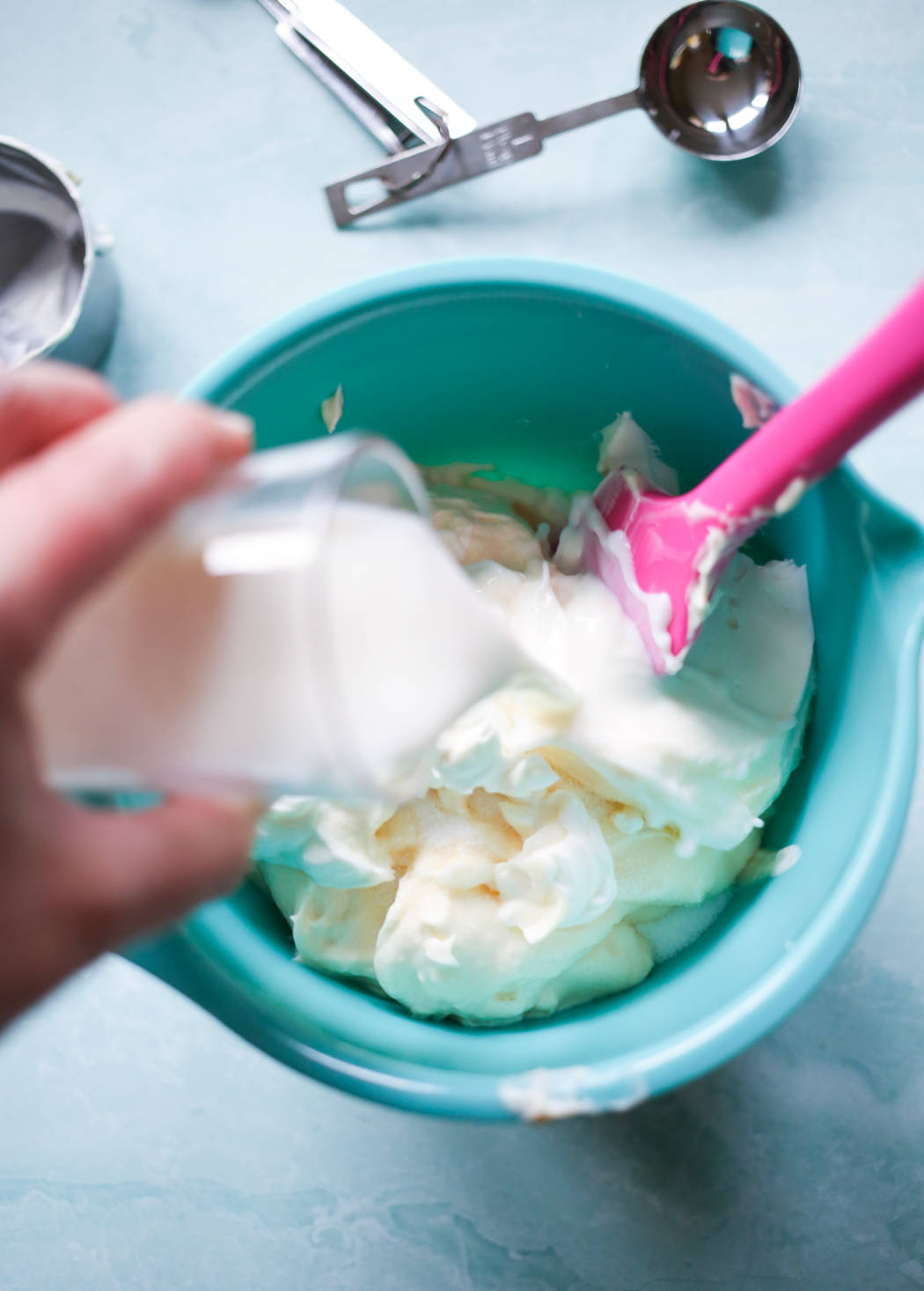 adding milk to macaroni salad dressing