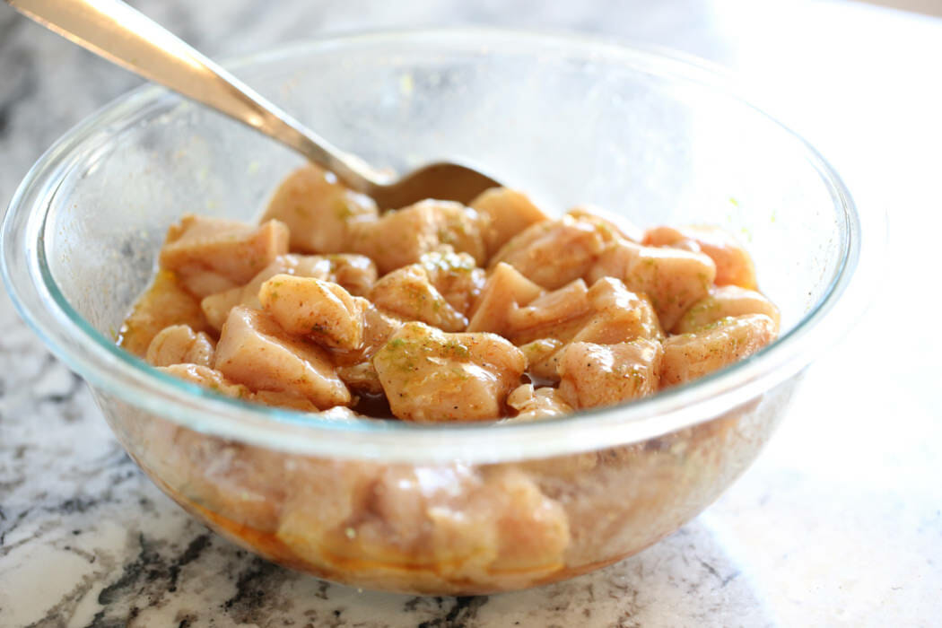 Chili-Lime Mango Chicken marinating in a bowl.