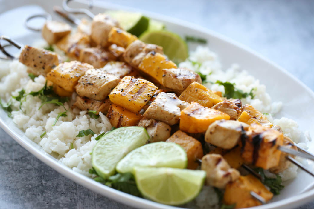 Chili-Lime Mango Chicken Skewers on a bed of white rice. 