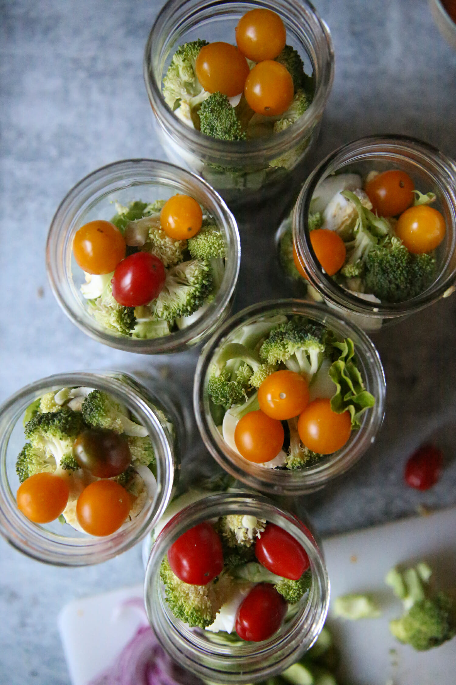 broccoli and tomatoes in salad jars