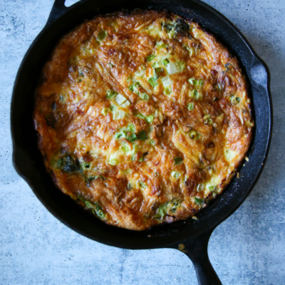 spinach and bacon frittata in a cast iron pan from our best bites