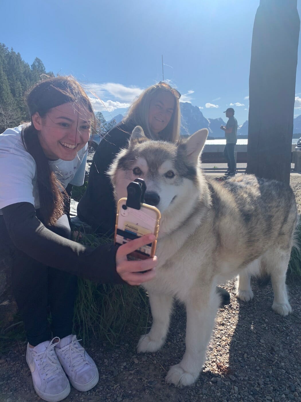 girl taking a selfie with a dog