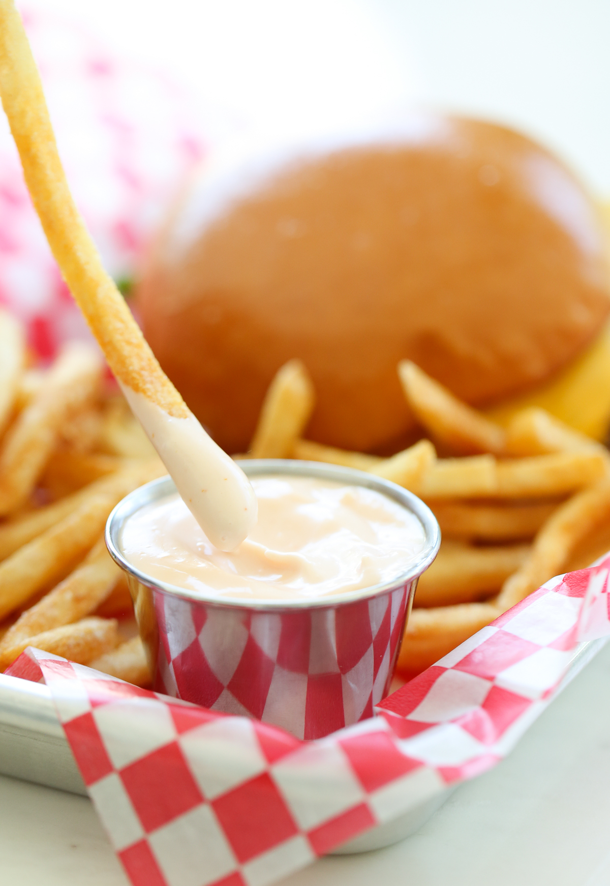 french fries being dipped in sauce
