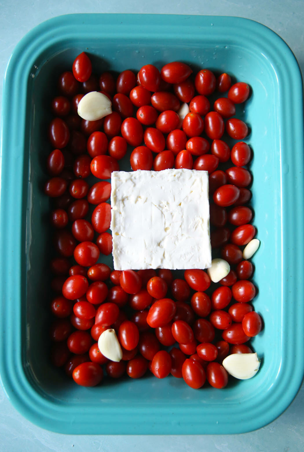 Feta, garlic, and tomatoes in a 9x13" baking dish