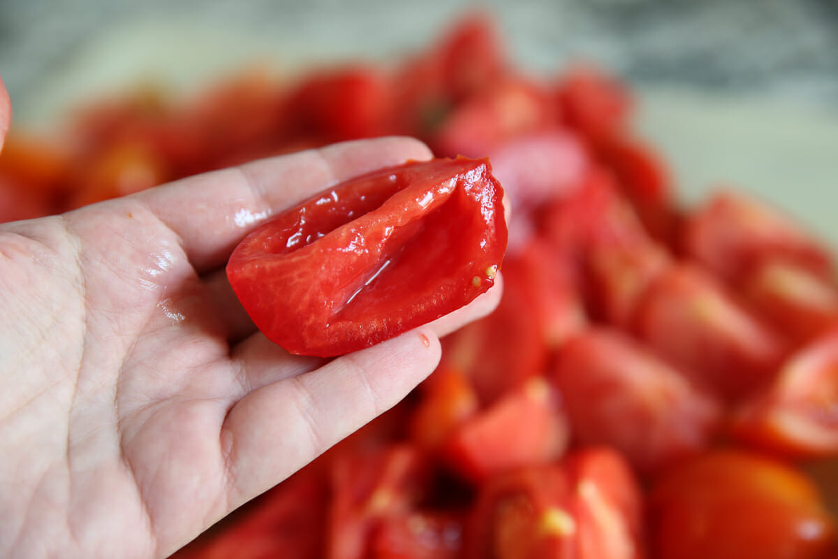 squeezing out pulp from fresh tomato