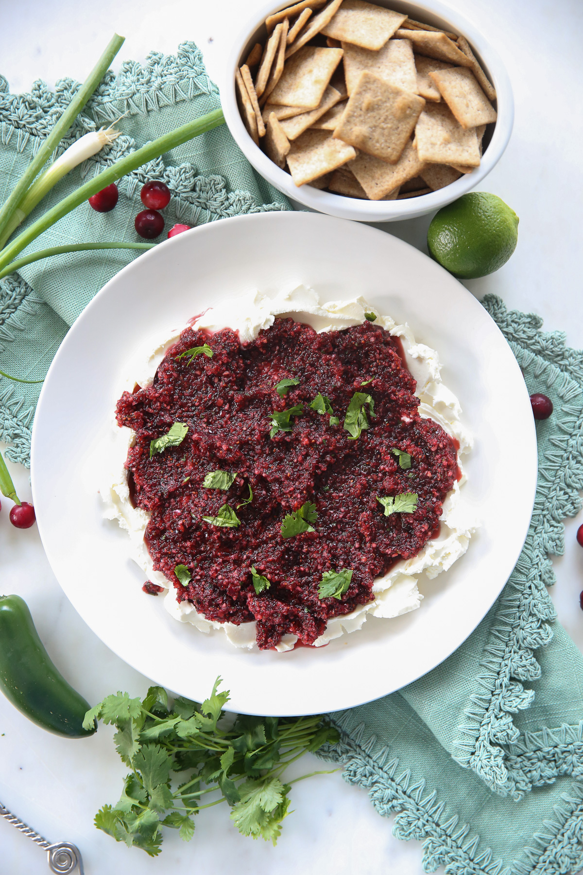 cranberry salsa over cream cheese on a white plate