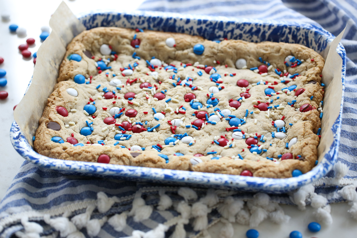 m and m cookie bars on a blue speckled plate