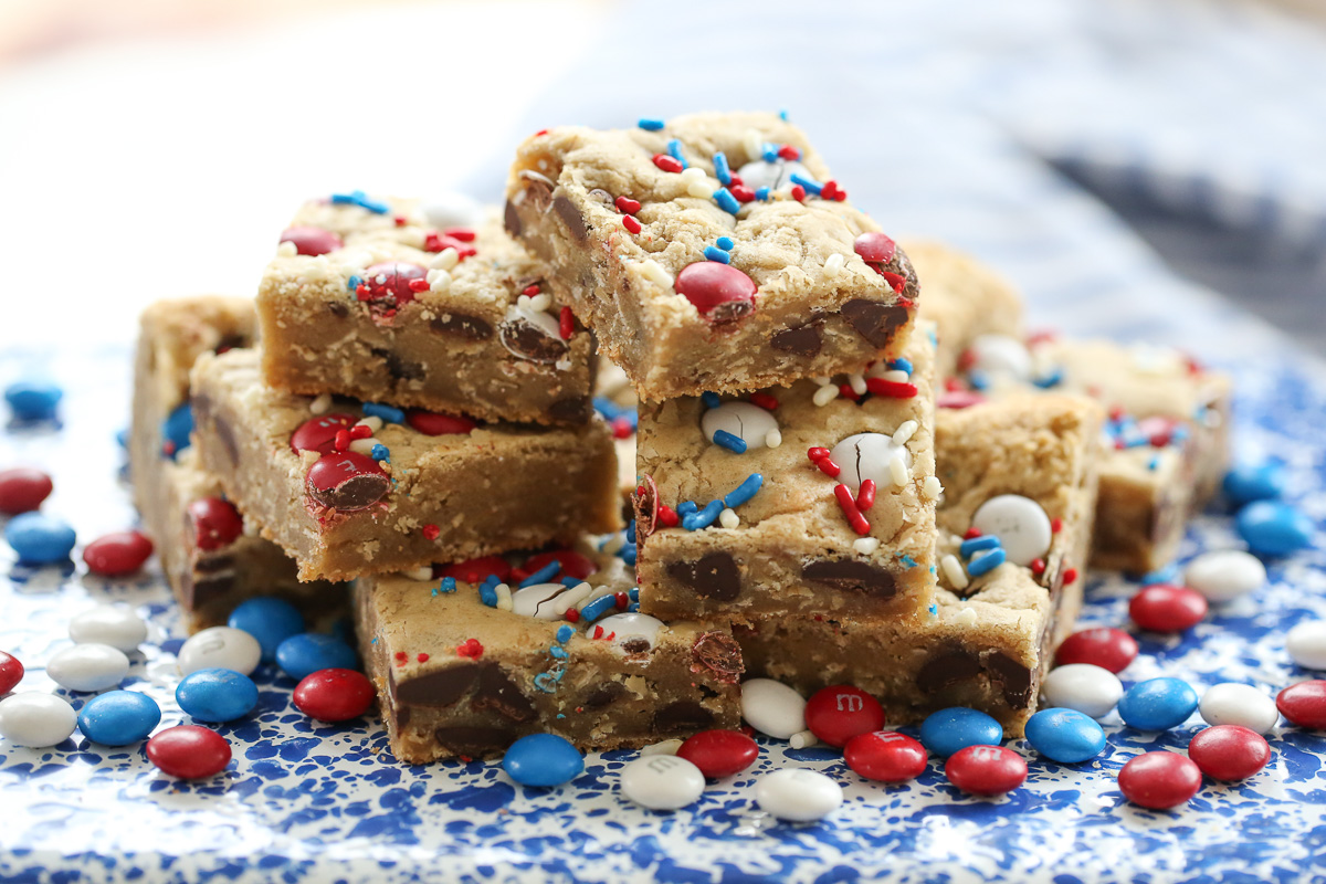 m and m cookie bars on a blue speckled plate