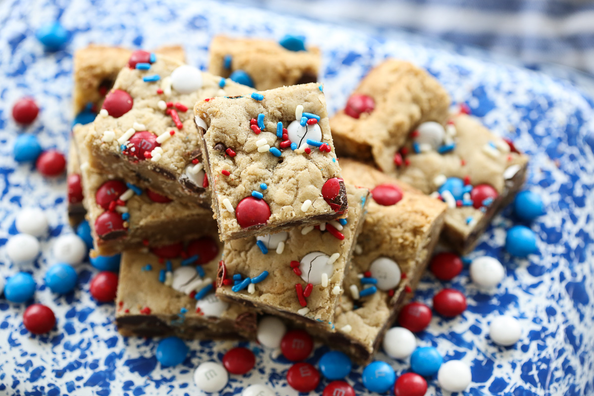 m and m cookie bars on a blue speckled plate