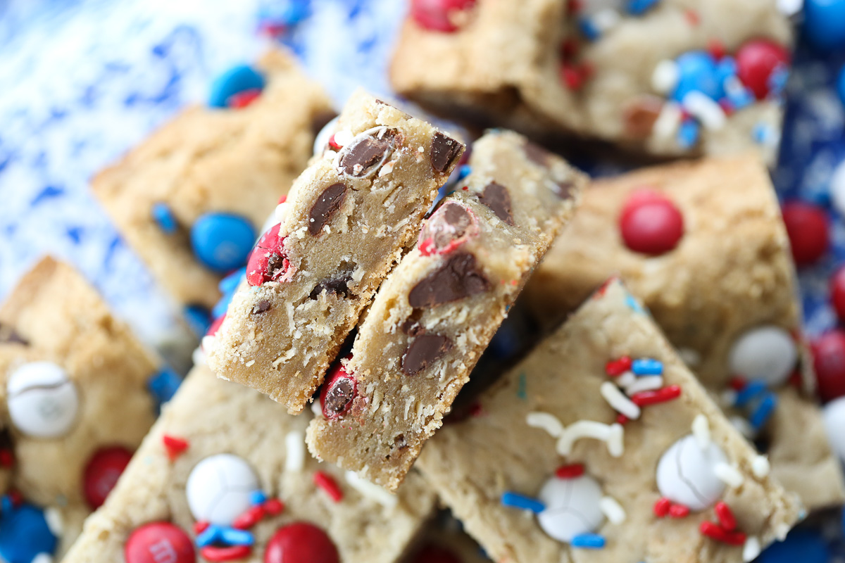 close up of sliced cookie bars with red white and blue m&M's on top