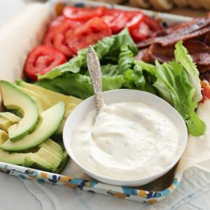 Garlic-Herb Mayo in a bowl, surrounded by other condiments.