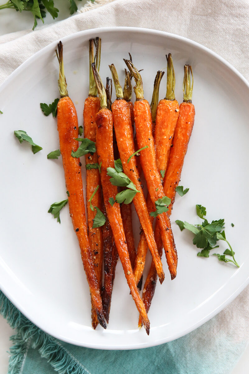 Roasted carrots on a white plate.