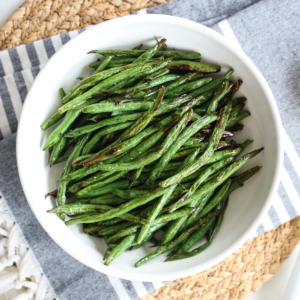 air fried green beans in white bowl