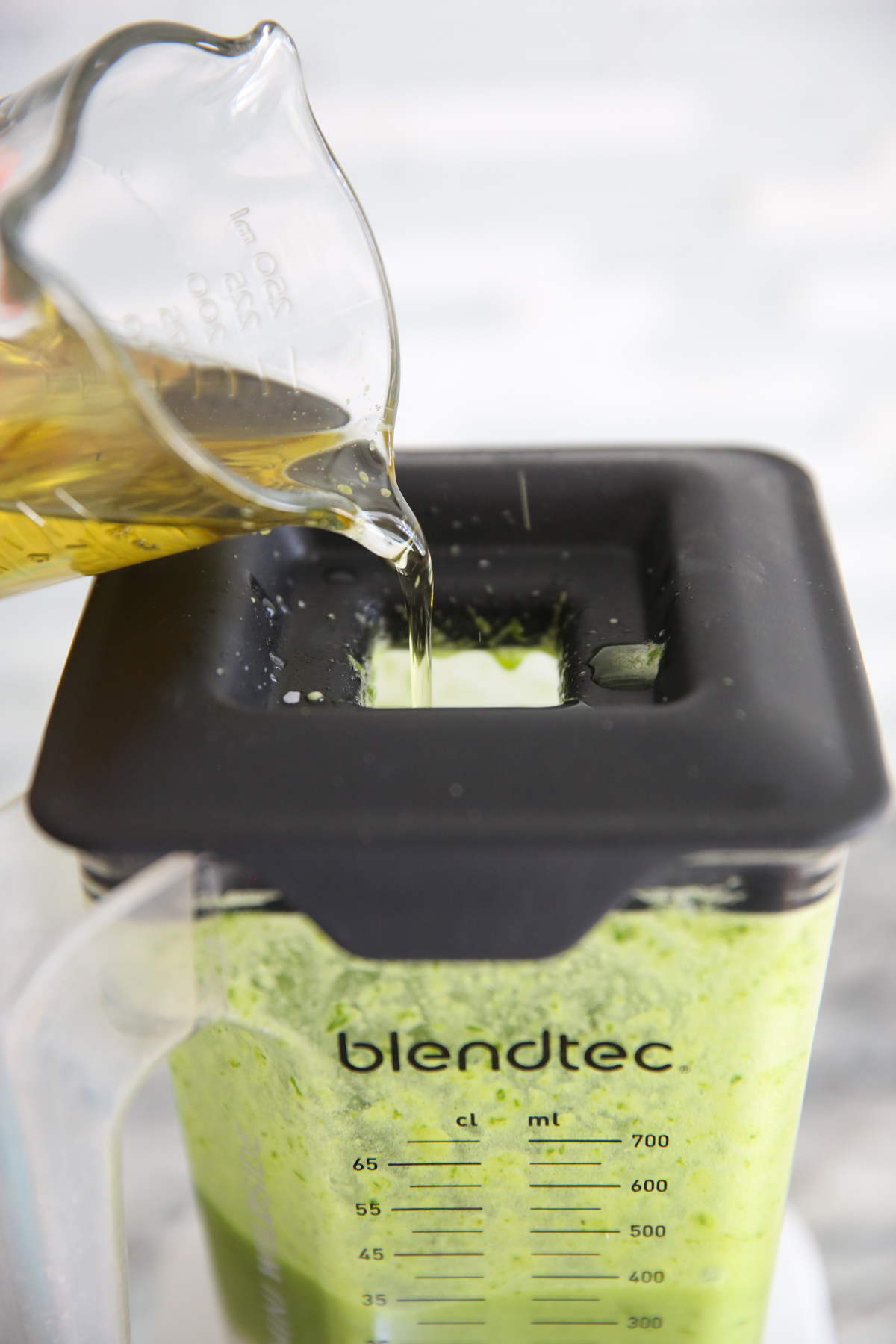 drizzling olive oil into a jar