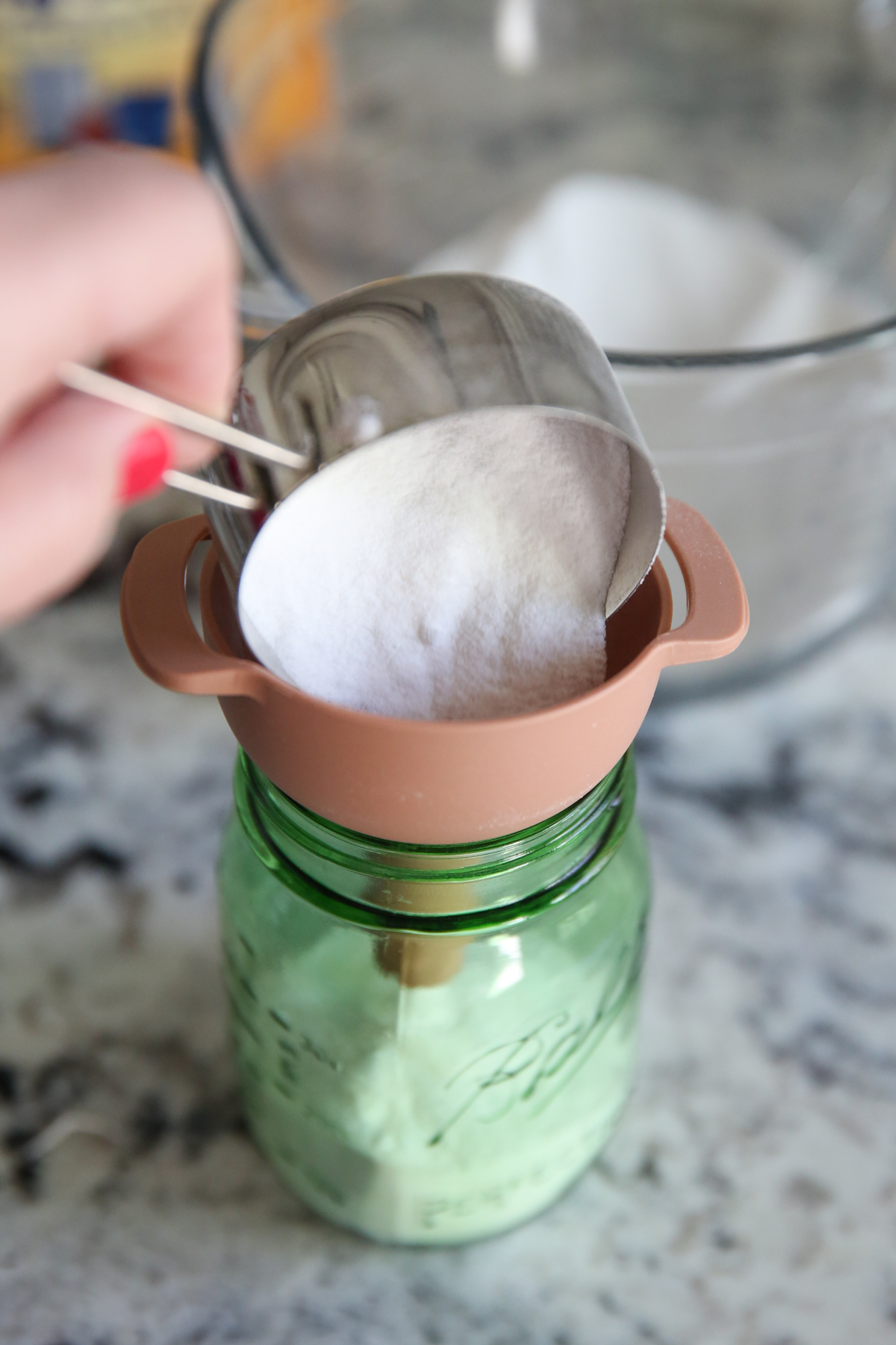 funneling sink scrub into jar