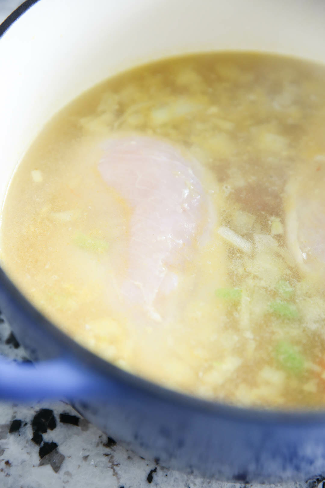 Chicken simmering in broth