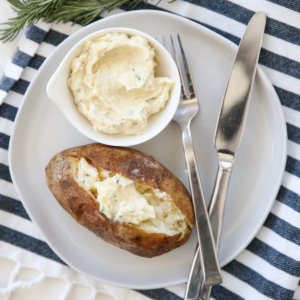 Baked potato on a plate with butter