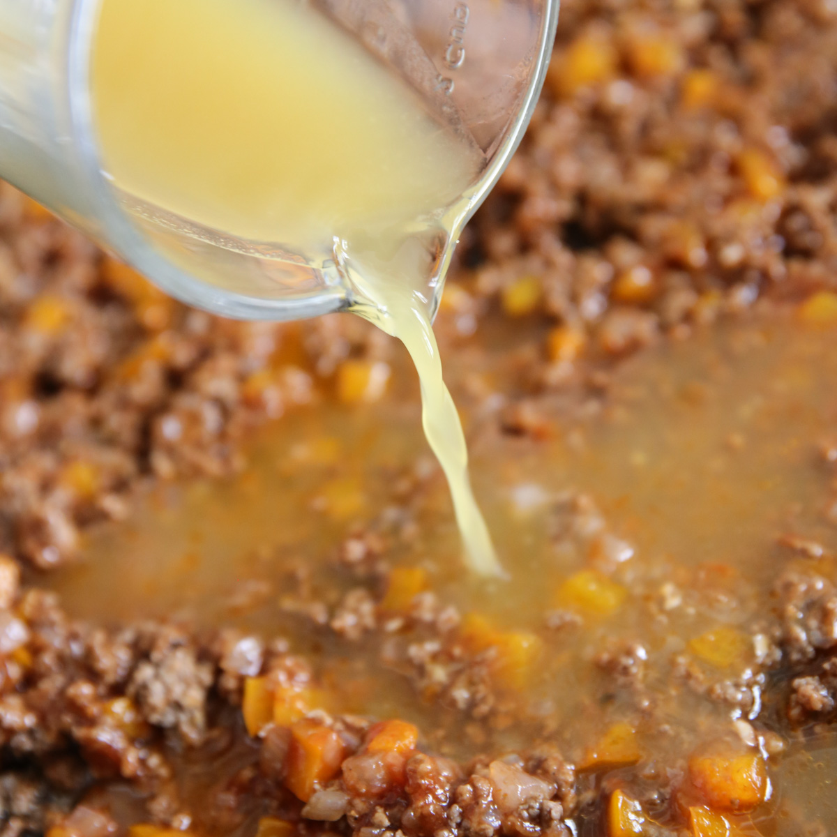 pouring pineapple juice into sloppy joes