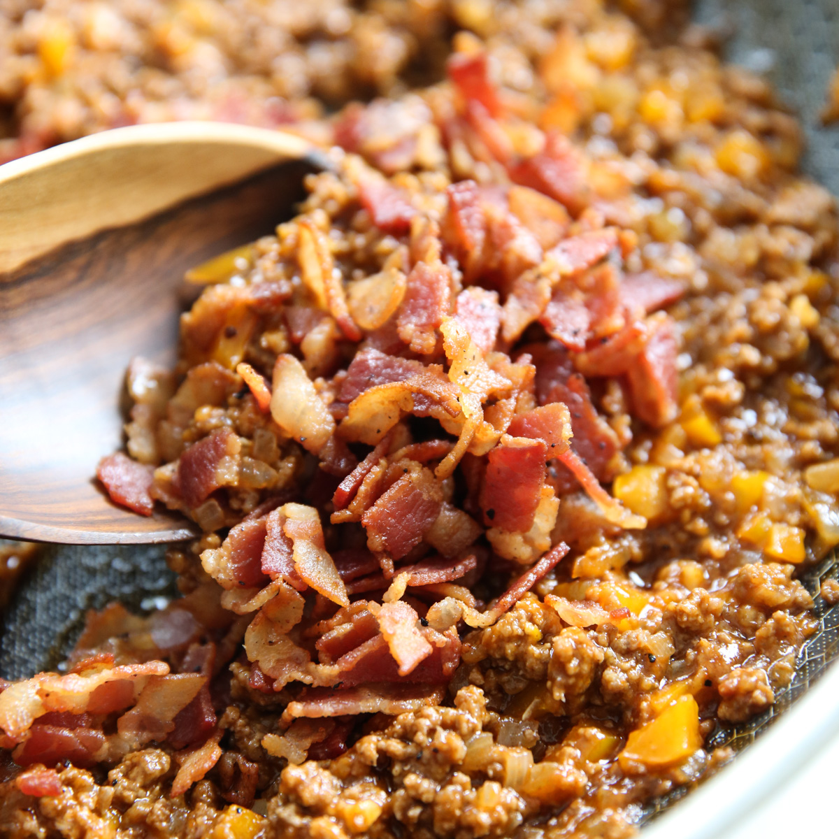 bacon in a skillet of ground beef and sauce