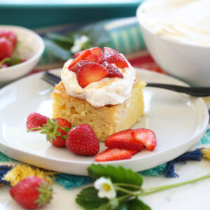 Tres Leches cake with whipped cream and strawberries