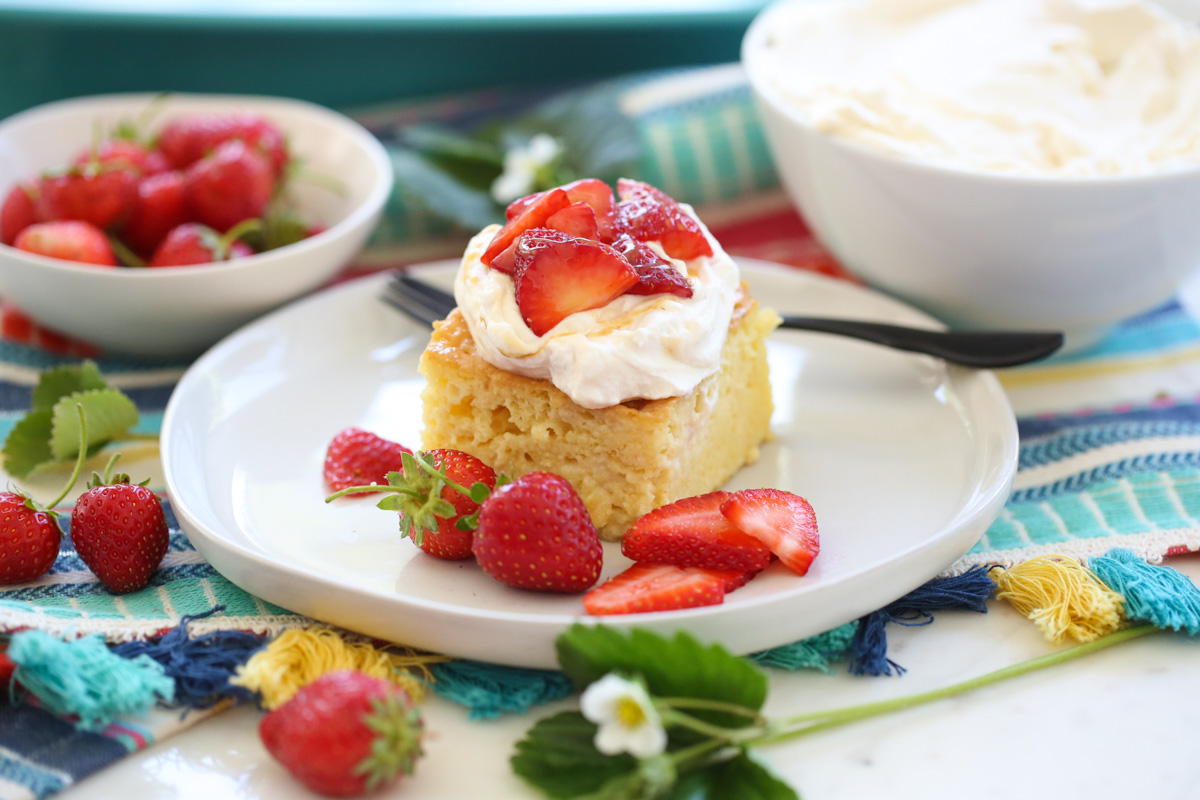 Tres Leches cake with whipped cream and strawberries