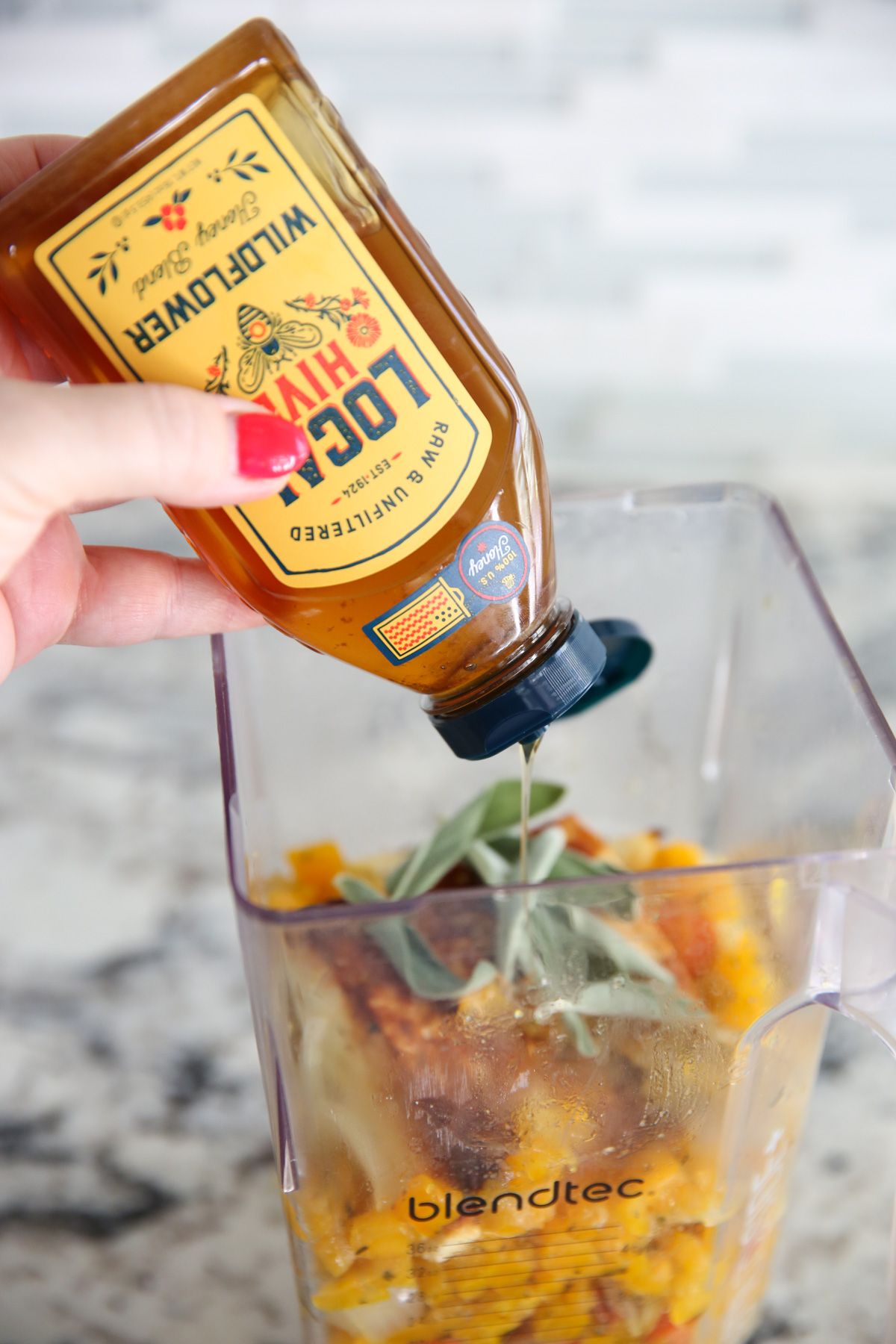 adding honey to blender