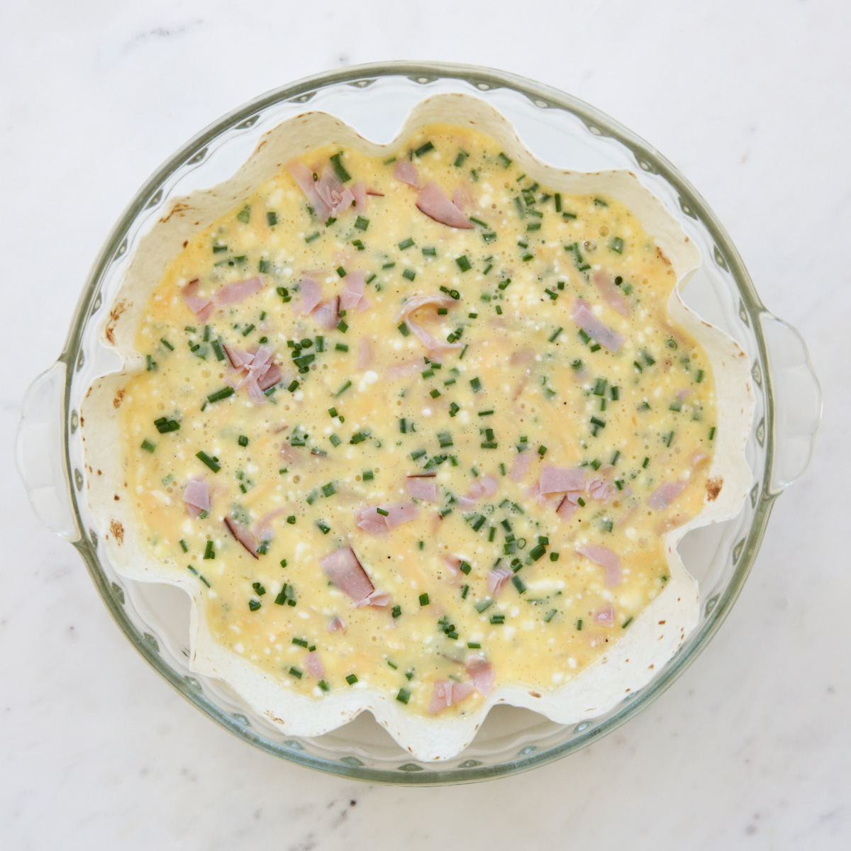 egg and cheese mixture in a pie plate