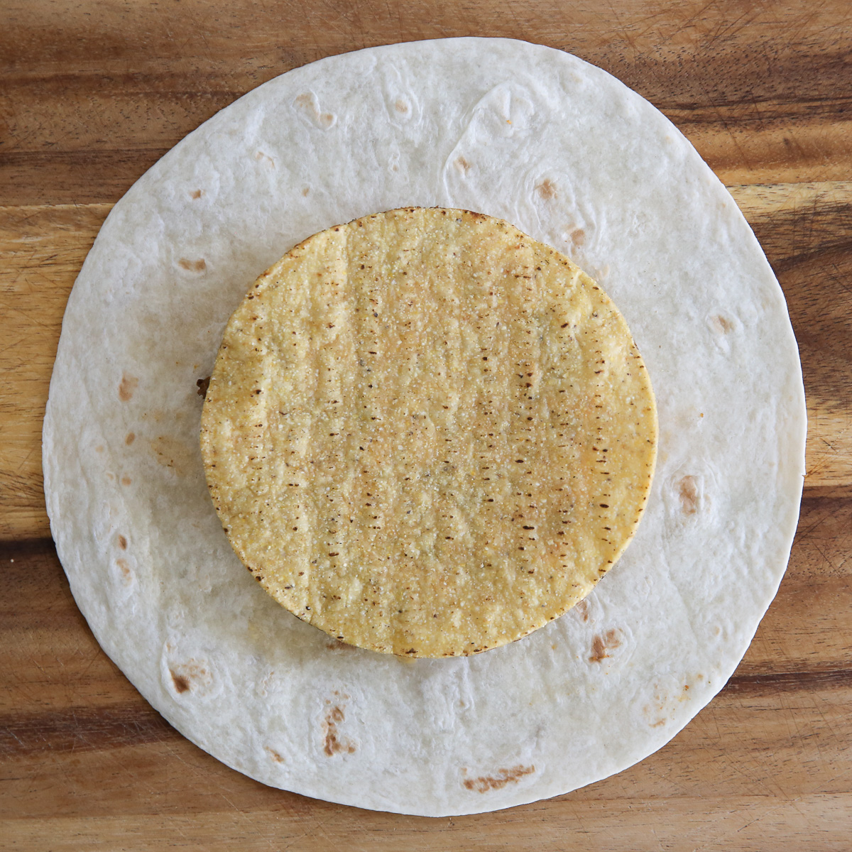 large tortilla with a small crisp tortilla on top