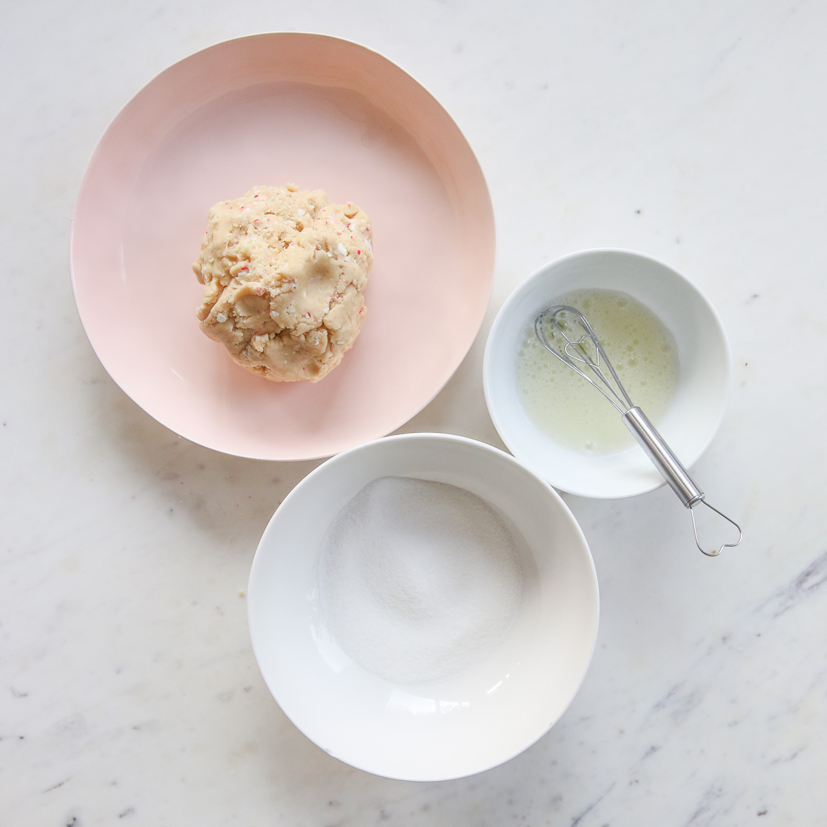 cookie dough, egg whites, and sugar in bowls