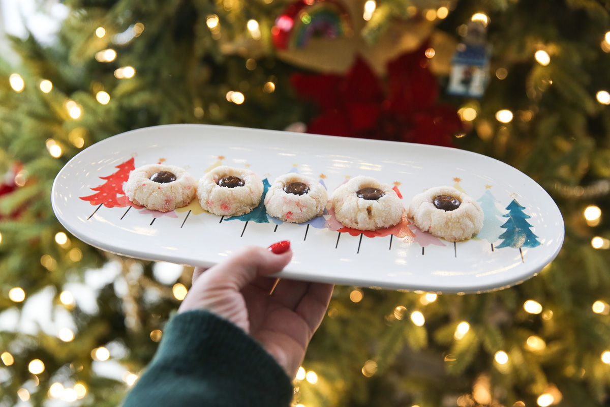 candy cane cookies on a platter in front of a Christmas tree