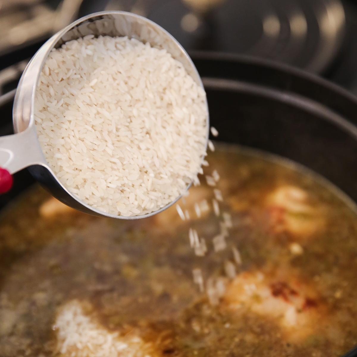 Adding Rice to Pot of Soup