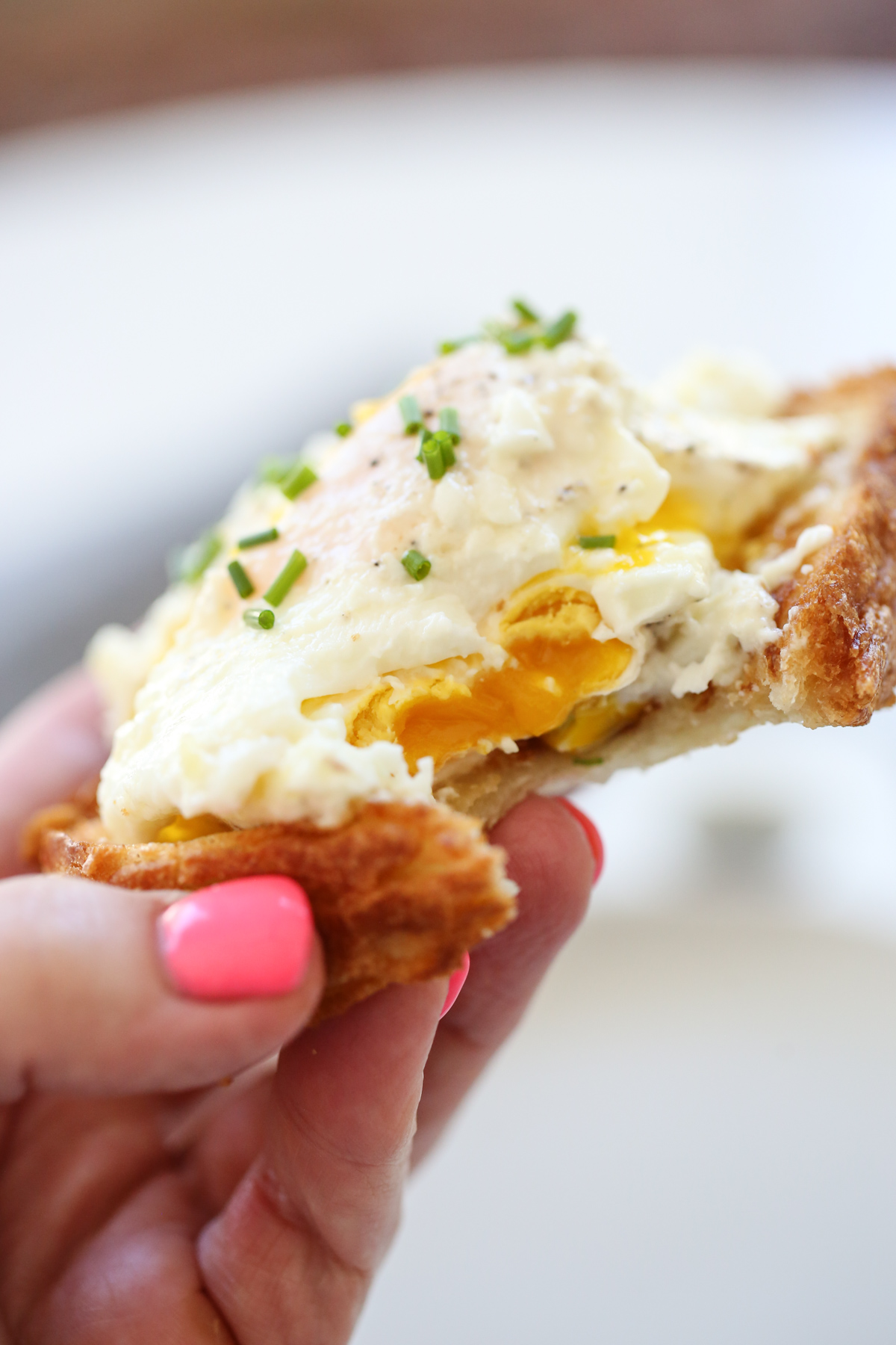cream fried egg on toast with chives