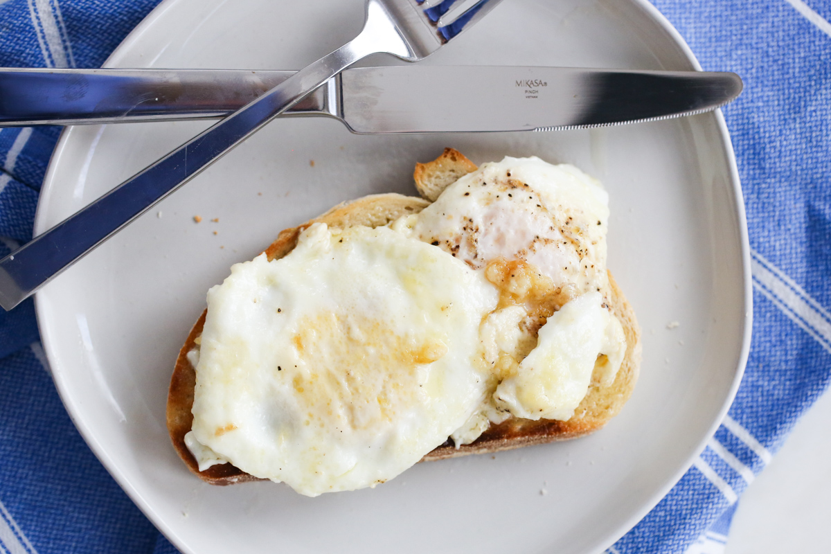 Cream fried eggs on a white plate